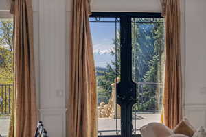 Entryway featuring a decorative wall, a wainscoted wall, and french doors