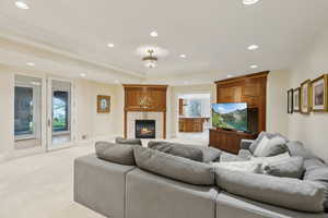 Living room featuring recessed lighting, a fireplace, visible vents, and a tray ceiling