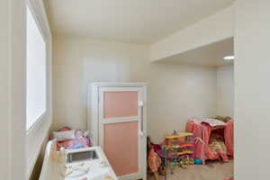 Playroom featuring carpet flooring and a sink