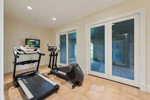 Workout area featuring recessed lighting, tile patterned flooring, and french doors
