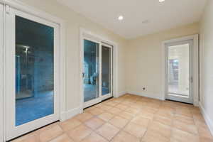 Unfurnished room featuring baseboards, recessed lighting, and light tile patterned flooring
