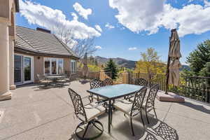View of patio with outdoor dining space and a mountain view