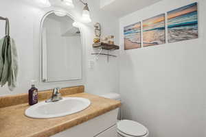 Half bathroom with vanity and toilet