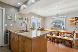 Kitchen featuring recessed lighting, light countertops, a sink, visible vents, and a peninsula