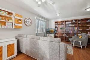 Living room with wood finished floors and a ceiling fan