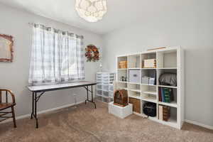 Carpeted office with baseboards and visible vents