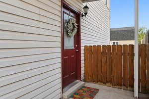 Doorway to property featuring fence