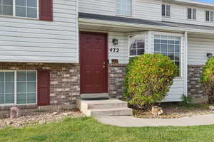 View of exterior entry featuring brick siding