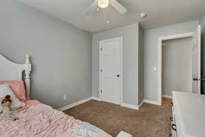 Bedroom with baseboards, carpet flooring, and ceiling fan