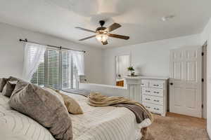 Bedroom with light carpet and ceiling fan