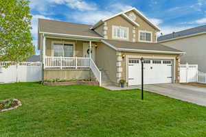 View of front of house featuring fence, an attached garage, covered porch, and stucco siding