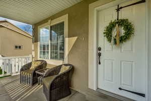 View of exterior entry featuring stucco siding