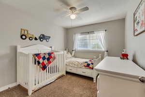 Bedroom featuring a ceiling fan and carpet floors