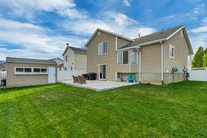 Back of property with a lawn, a patio area, and a fenced backyard