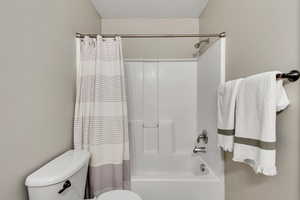 Full bathroom with shower / tub combo and toilet