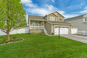 View of front facade featuring concrete driveway, covered porch, an attached garage, fence, and stucco siding