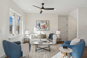 Living room with recessed lighting, a ceiling fan, wood finished floors, and baseboards