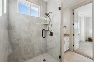 Primary bathroom with a shower stall and vanity