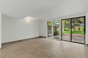Empty room with visible vents and baseboards