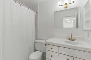 Full bath featuring toilet and vanity