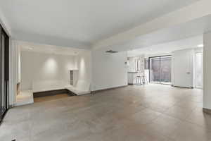 Empty room featuring recessed lighting, light tile patterned flooring, visible vents, and baseboards