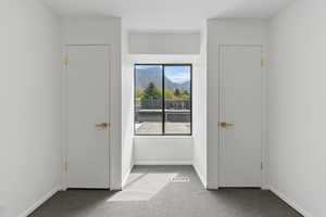 Unfurnished bedroom with carpet floors and baseboards