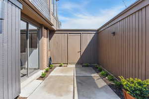 View of patio featuring fence