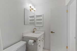 Bathroom with tile patterned floors, toilet, and vanity