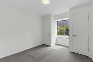 Unfurnished bedroom featuring visible vents, carpet floors, and baseboards