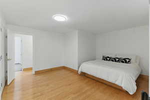 Bedroom featuring light wood finished floors and baseboards