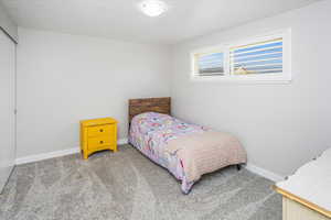 Carpeted bedroom featuring baseboards