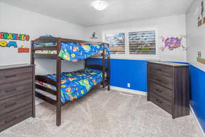 Carpeted bedroom with baseboards