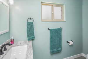 Bathroom with a sink and baseboards