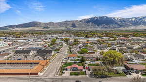 Birds eye view of property with a mountain view and a residential view