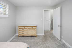 Bedroom featuring baseboards and light colored carpet