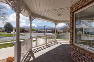 View of patio / terrace with a residential view, covered porch, and a mountain view
