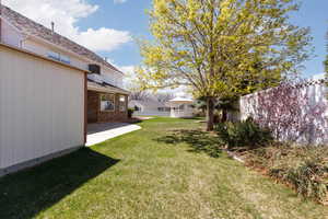 View of yard featuring a gazebo, a patio, and fence