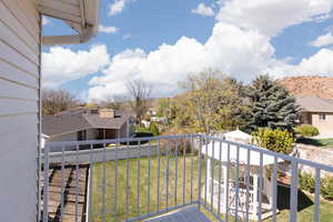 Wooden terrace featuring fence, a yard, and a residential view