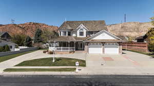 Victorian home with concrete driveway, an attached garage, fence, a porch, and brick siding