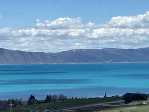 Property view of mountains with a water view