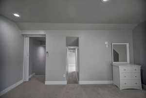 Unfurnished bedroom with light colored carpet, recessed lighting, and baseboards