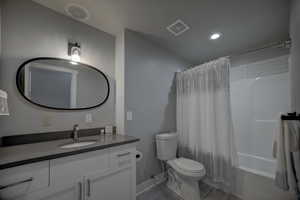 Full bath featuring recessed lighting, vanity, shower / bath combo with shower curtain, toilet, and visible vents