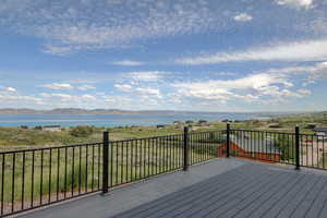 Deck with a water and mountain view