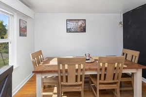 Dining area with light wood-style flooring, a wealth of natural light, and baseboards
