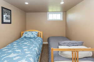 Bedroom featuring recessed lighting, carpet, and baseboards