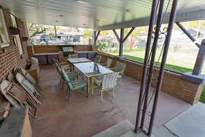 View of patio / terrace featuring area for grilling, outdoor dining space, an outdoor kitchen, and fence