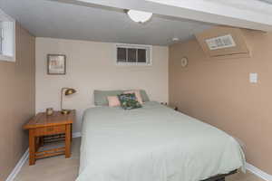 Bedroom featuring visible vents, light wood-style flooring, and baseboards