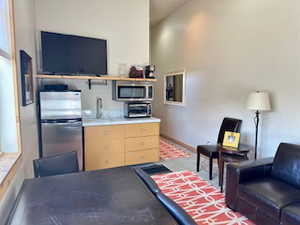 ADU Kitchen with a toaster, light countertops, light brown cabinets, a sink, and appliances with stainless steel finishes