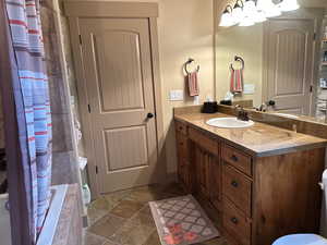 Primary bathroom with vanity, tiled shower / bath combo