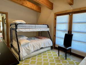 Bedroom In the ADU  with beamed ceiling